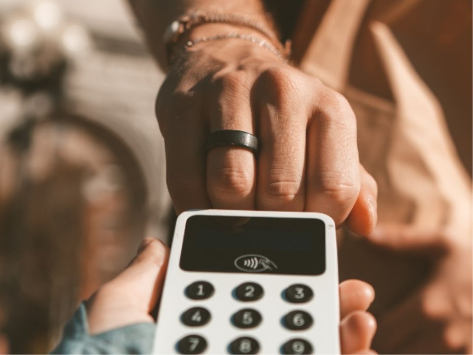 Pays the bill using a Tapster wearable device.